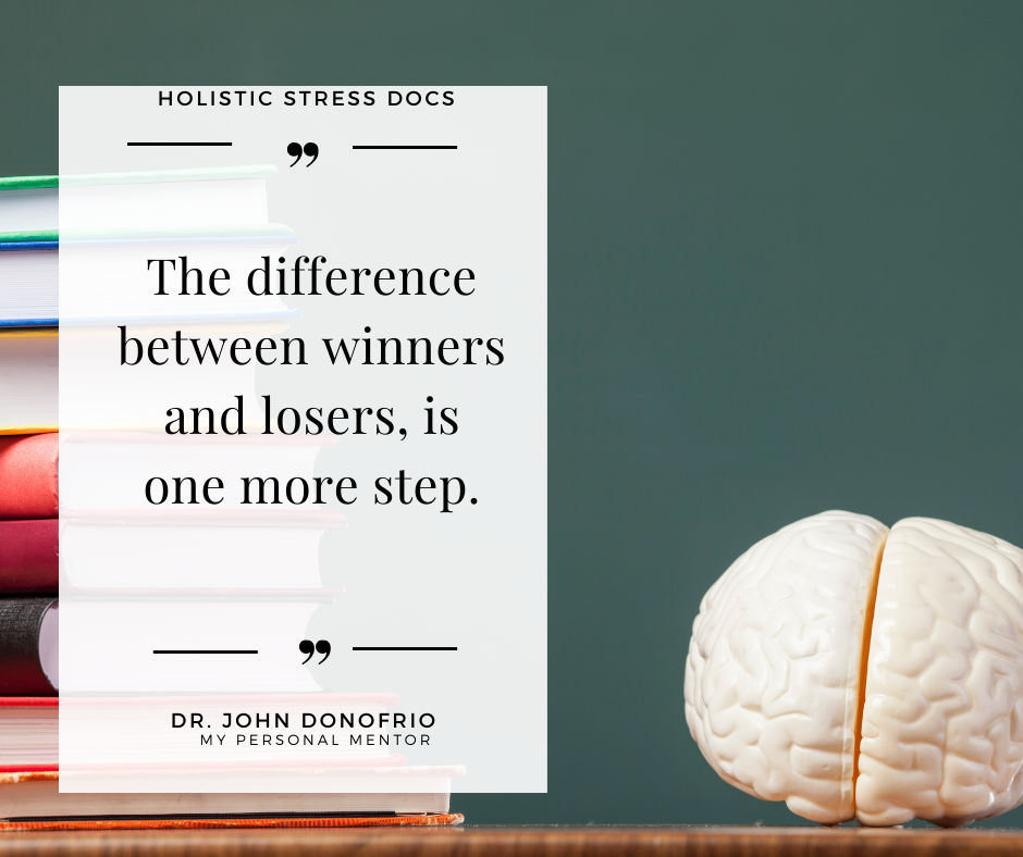 Stack of books with brain model and motivational quote for students