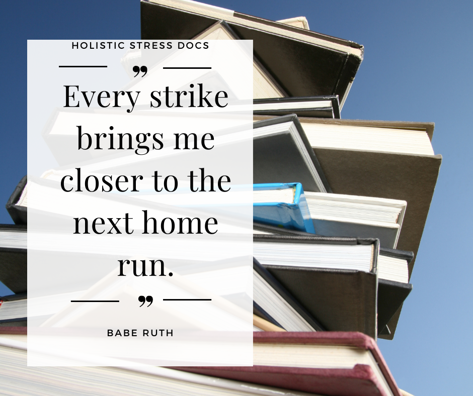 Stack of books with motivational exam quote