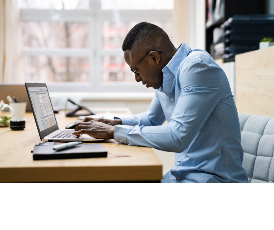 Man sitting at desk with computer with bad posture