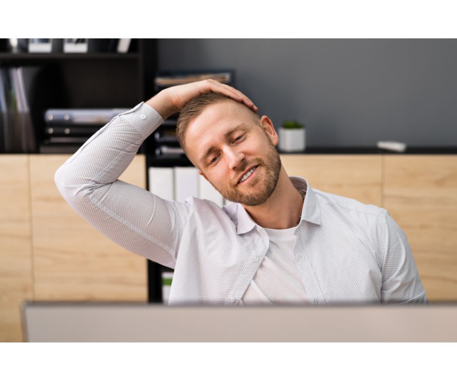 man at desk stretching neck in lateral flexion