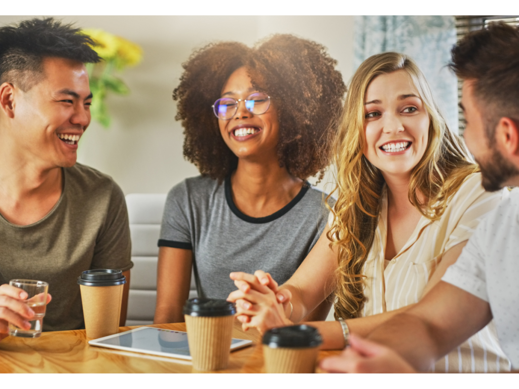 a group of 4 friends happily conversating and how to decrease symptoms of stress with meaningful friendships