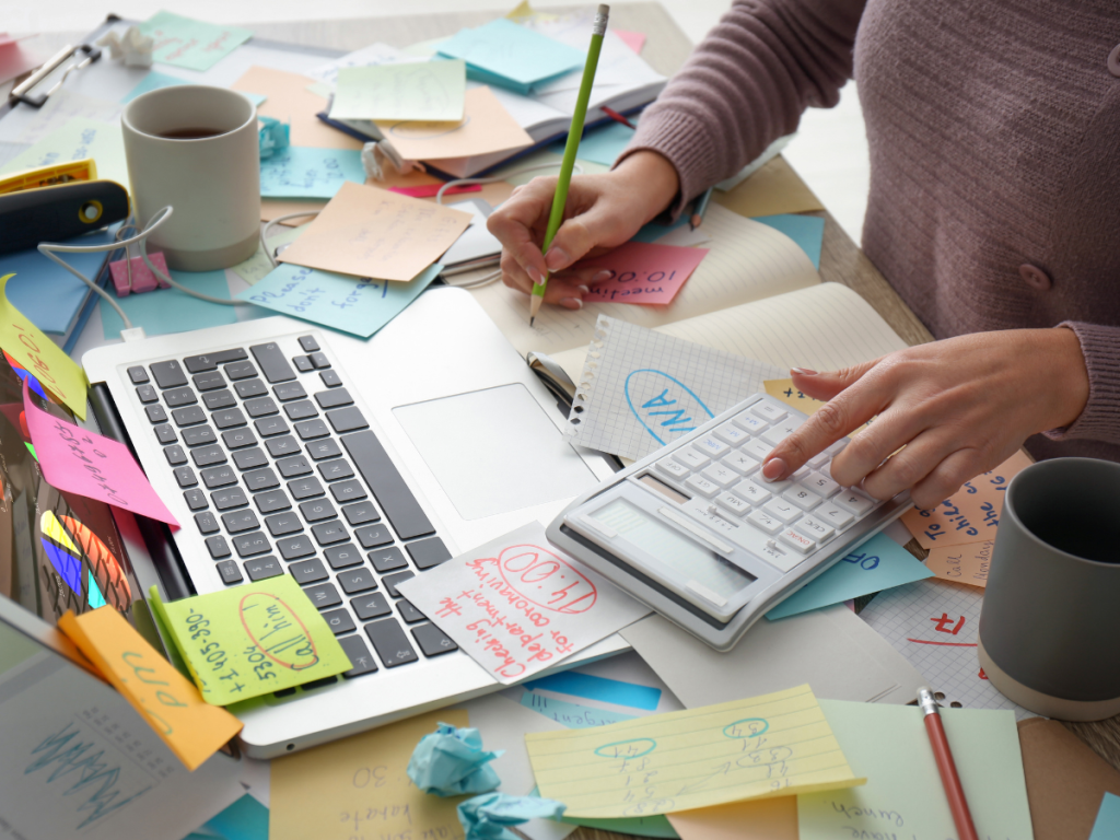 chronic stress demonstrated with laptop and tons of sticky notes to show What is a Stress Reaction and How to Decrease Symptoms once it has become chronic