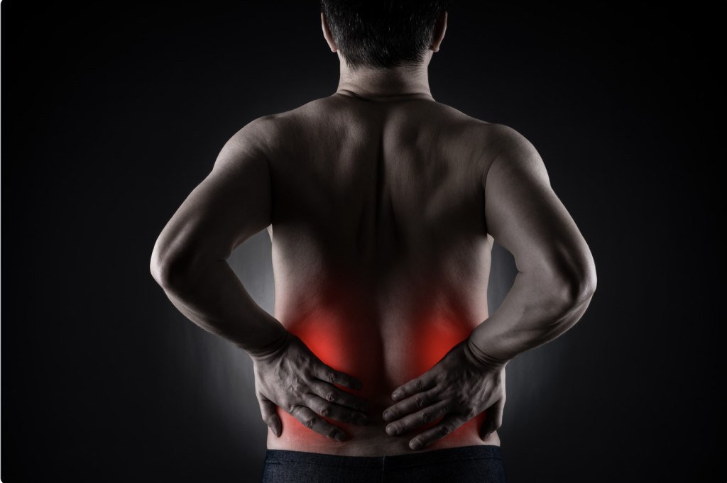 A man holding his low back because it has aches and pains
