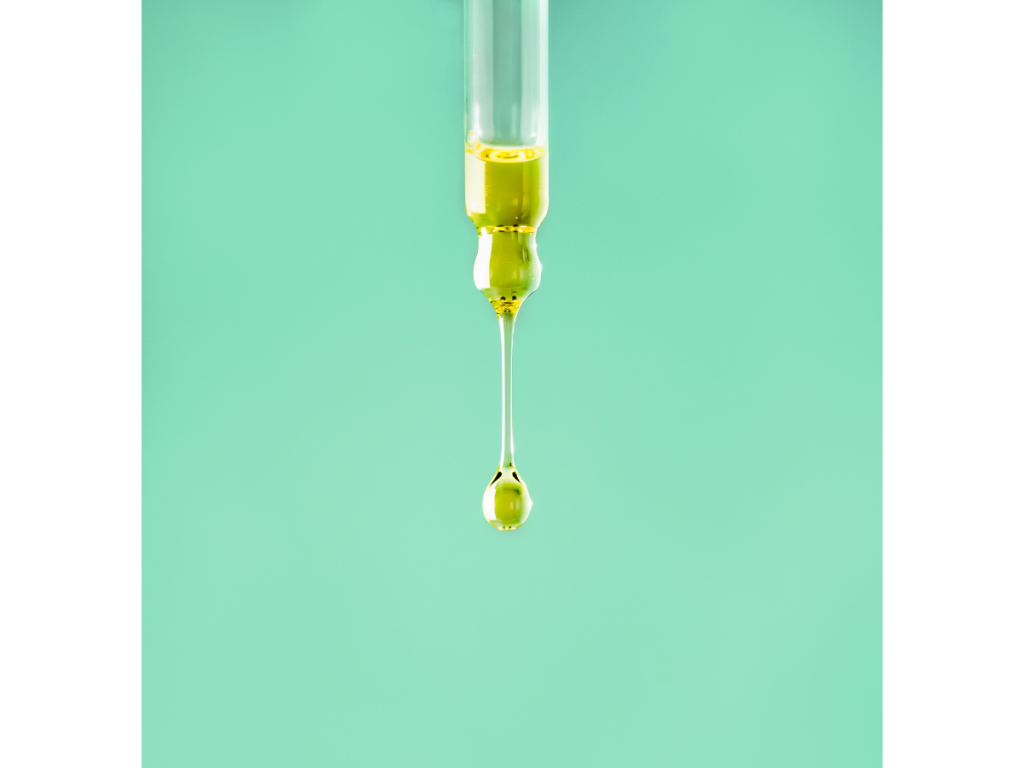 Vitamin E oil dripping out of glass vial as an ingredient for Best Anti-Aging Treatments and Products for 30s