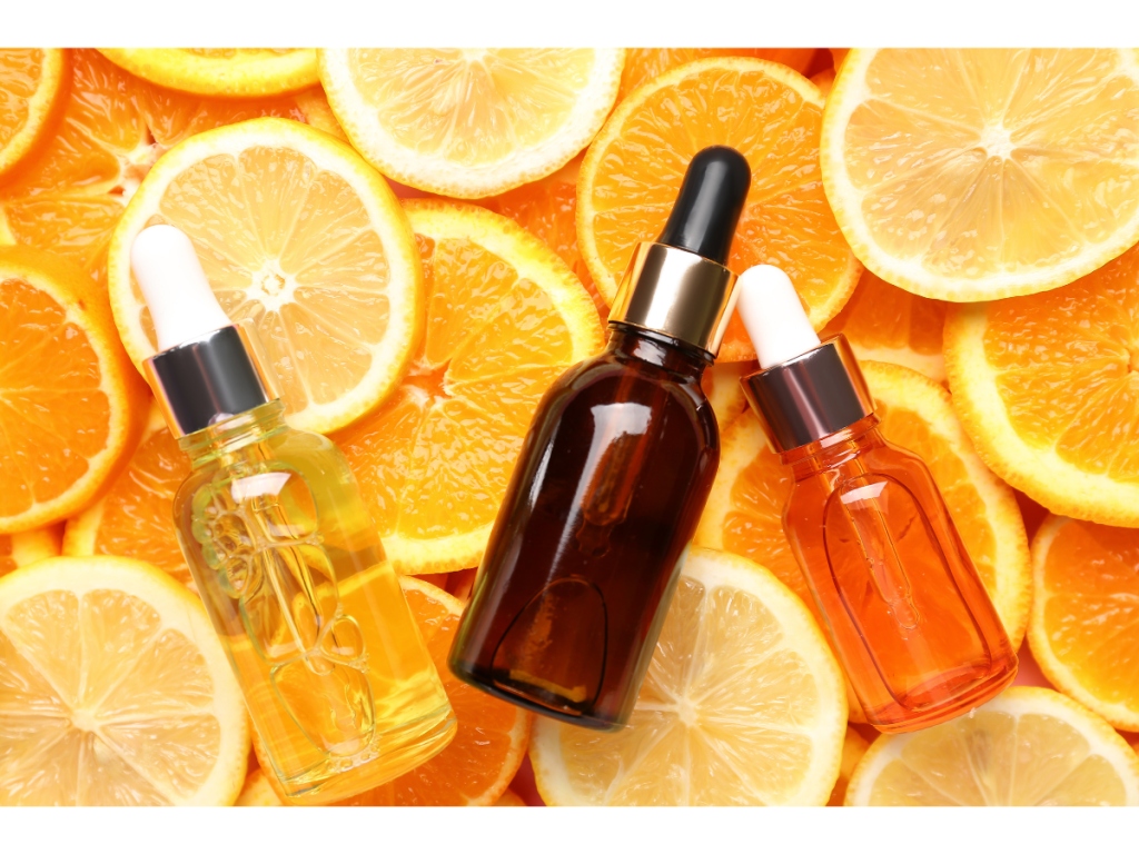 Vitamin C in bottles on top of cut oranges as an ingredient for Best Anti-Aging Treatments and Products for 30s