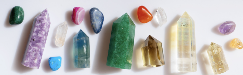 Multiple sizes, colors, and shapes of stones on a white surface.