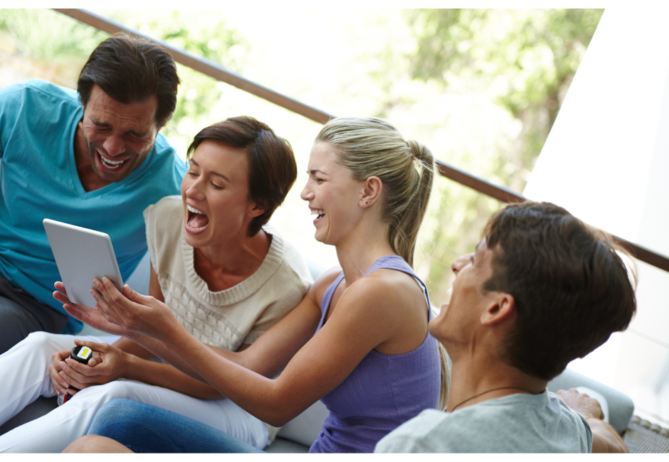 2 women and 2 men laughing as a way to keep your brain and nervous system healthy by decreasing stress