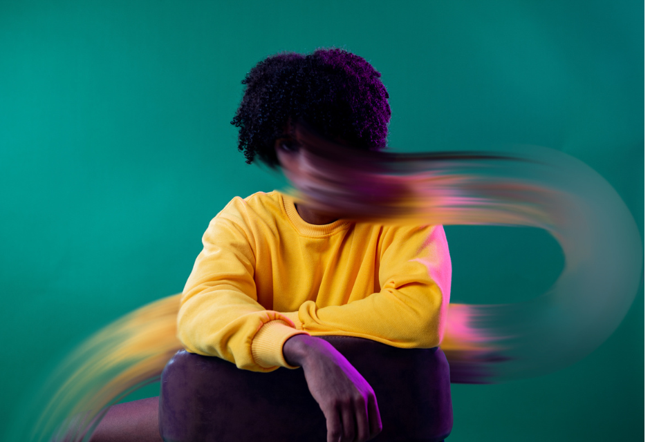 Person with dark hair in yellow shirt with smeared face to represent a dysregulated nervous system